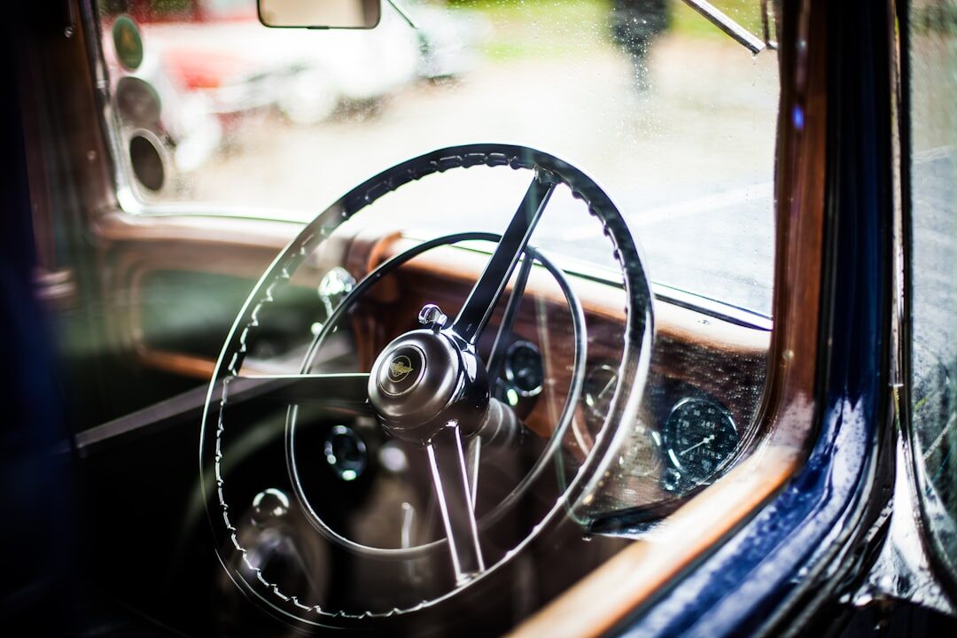 Close up of a vintage automobile leather interior with wood dashboard trim