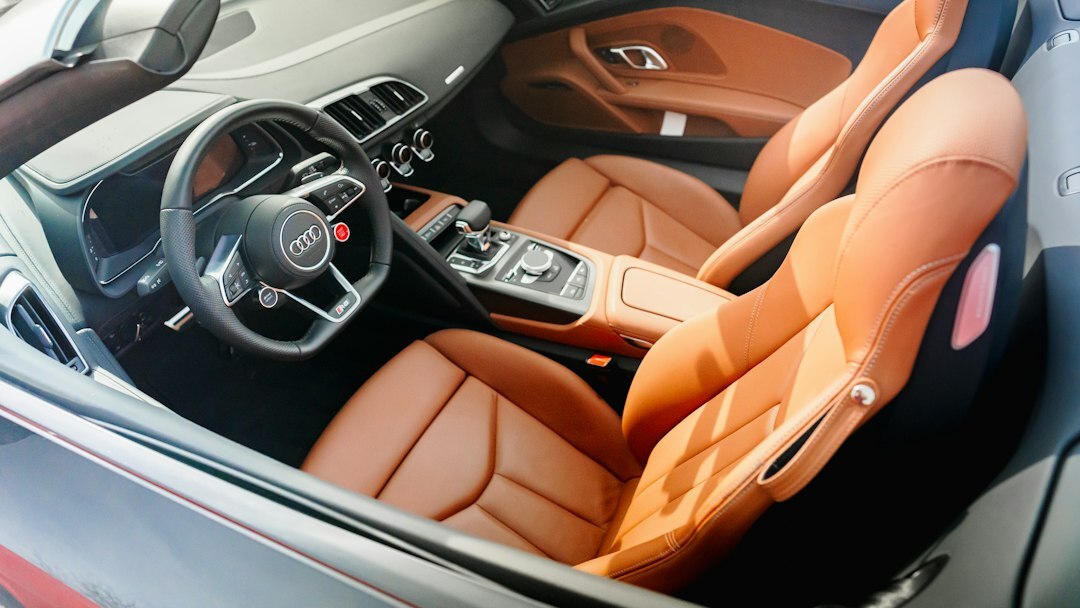 Interior view of a luxury automobile with leather seats and wood trim